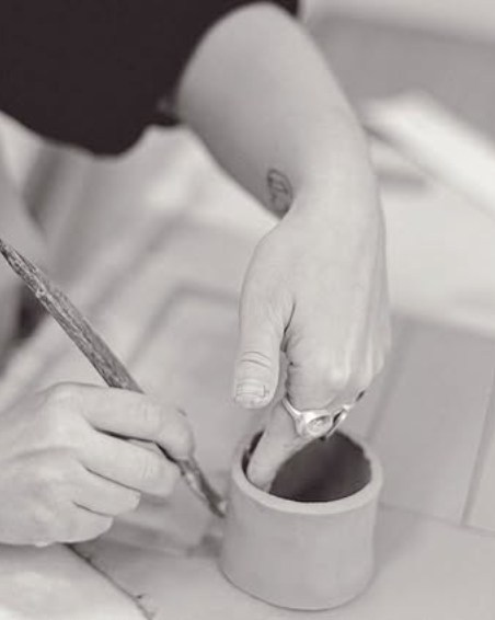 Hand-glazing a ceramic mug